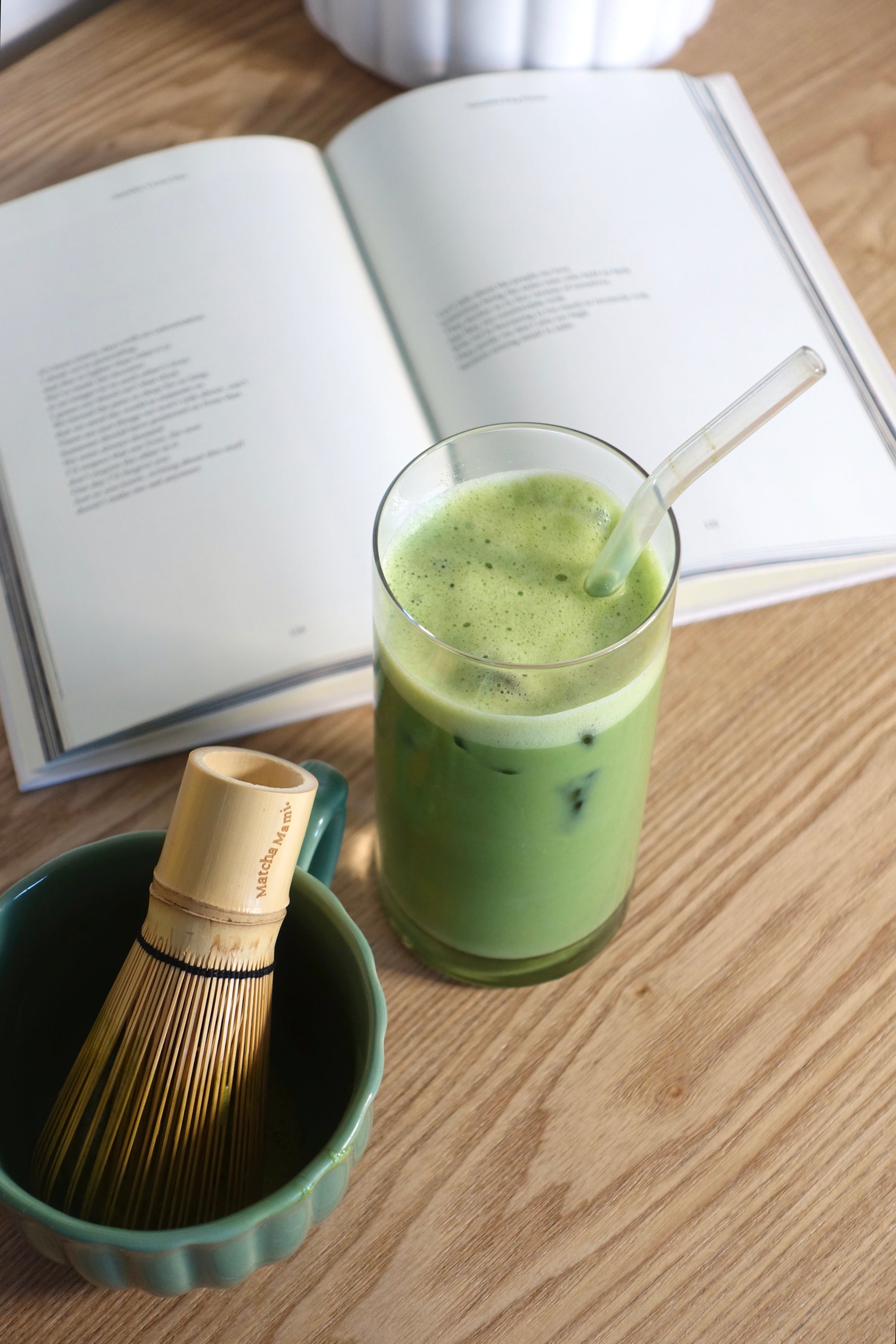 bamboo whisk chasen in a bowl with a matcha drink